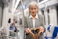 Mature woman amazed by theft from her bag in subway car Royalty Free Stock Photo