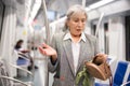 Mature woman amazed by theft from her bag in subway car Royalty Free Stock Photo
