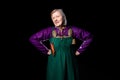 Mature woman in antique clothes posing hands on hips. A vibrant mix of purple and green Royalty Free Stock Photo