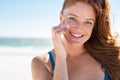 Mature woman applying sunscreen on face Royalty Free Stock Photo