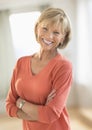 Mature Woman With Arms Crossed Standing At Home Royalty Free Stock Photo