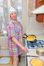 Mature woman bakes pancakes