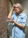 Mature woman beautiful girl considers exhibits in museum.