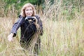 Mature woman with binoculars in high grass, bird watcher, copy space Royalty Free Stock Photo