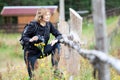 Mature woman bird watcher standing near wooden fence with binocular for birdwatching as a hobby Royalty Free Stock Photo