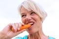 Mature woman bites in a carrot Royalty Free Stock Photo