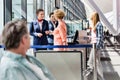 Mature woman on board giving her passport and boarding pass in airport