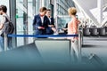 Mature woman on board scanning her ticket on smartphone in airport