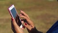 Mature woman browses internet with the use of mobile smartphone