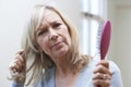 Mature Woman With Brush Corncerned About Hair Loss Royalty Free Stock Photo