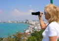 Mature woman with camera. Pattaya View of Pattaya viewpoint from Pratumnak Hill
