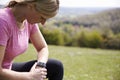 Mature Woman Checking Activity Tracker Whilst On Run