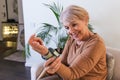 Mature Woman Checking Blood Pressure. Close up view of a blood pressure monito on hand. Digital tonometr on human hand. Portrait