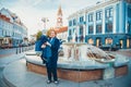 Mature woman with child in Vilnius old city fountain