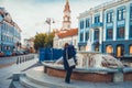 Mature woman with child in Vilnius old city fountain