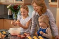 Mature woman, children and smile for baking in retirement for family, fun and bonding at home. Happy, female pensioner Royalty Free Stock Photo