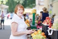 Mature woman chooses fruits