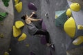 Mature woman climbs an exercise mountain at gym