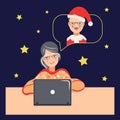 A mature woman communicates remotely with a man in a Christmas hat Royalty Free Stock Photo