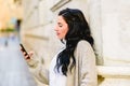 Mature woman confused and lost consulting her mobile phone Royalty Free Stock Photo