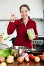 Mature woman cooking lent diet soup with rice Royalty Free Stock Photo