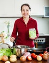 Mature woman cooking soup with rice Royalty Free Stock Photo