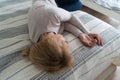 Mature woman curled lying on the bed at home top view. Depression, mental health, abuse problem Royalty Free Stock Photo