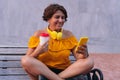 Mature woman with disposable coffee cup using cell phone in park Royalty Free Stock Photo