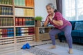 Smiley face of retirement woman doing exercise with squats pose