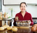 Mature woman with dried mushrooms Royalty Free Stock Photo