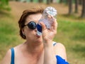 Mature woman drinking water from a bottle