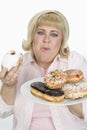 Mature Woman Eating Donuts Royalty Free Stock Photo