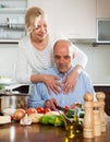 Mature woman with elderly senior preparing vegetarian food together
