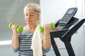 Mature woman exercising with free weights at home. Stay at home, active seniors, home quarantine concept Royalty Free Stock Photo