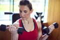 Mature Woman Exercising In Home Gym Lifting Hand Weights Royalty Free Stock Photo