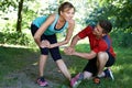 Mature Woman Exercising With Personal Trainer In Park Royalty Free Stock Photo