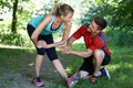 Mature Woman Exercising With Personal Trainer In Park Royalty Free Stock Photo