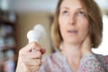 Mature Woman Experiencing Hot Flush From Menopause Using Electric Fan Royalty Free Stock Photo