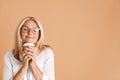 Mature woman in eyeglasses smiling while drinking coffee Royalty Free Stock Photo