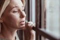 Mature woman with facial wrinkles feeling stressed and sad