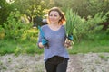 Mature woman farmer walking through the garden with green fresh chive onion Royalty Free Stock Photo