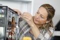 mature woman fixing computer Royalty Free Stock Photo