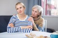 Mature woman gently hugged her adult daughter