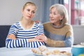 Mature woman gently hugged her adult daughter