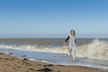 Mature woman getting splashed in the sea