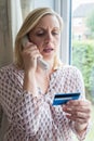 Mature Woman Giving Credit Card Details On The Phone Royalty Free Stock Photo