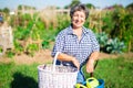 Mature woman having horticultural instruments in garden on day