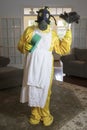 Mature woman in Haz Mat suit with feather duster and sponge Royalty Free Stock Photo