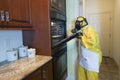 Mature woman in Haz Mat suit opening oven door Royalty Free Stock Photo