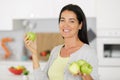Mature woman holding apples at home Royalty Free Stock Photo